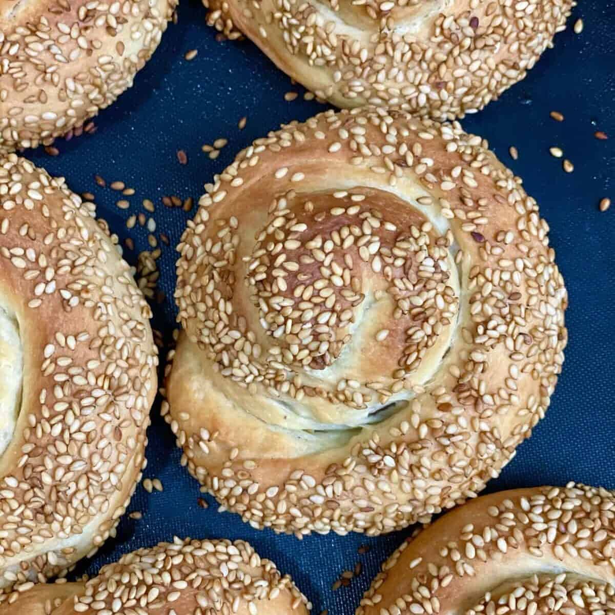 a top view of homemade baked brioche bread stuffed with dates and topped with sesame