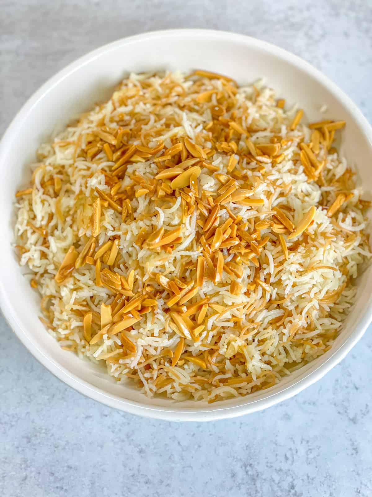 top view of fluffy vermicelli rice topped with golden toasted almond slivers