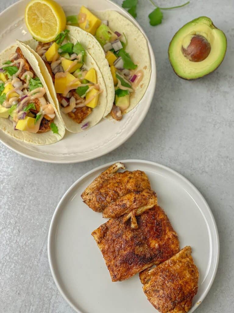 Delicious blackened mahi mahi fish turned into flavor-packed tortilla tacos that are easy and packed with mangoes, avocado, cilantro, and a mahi sauce