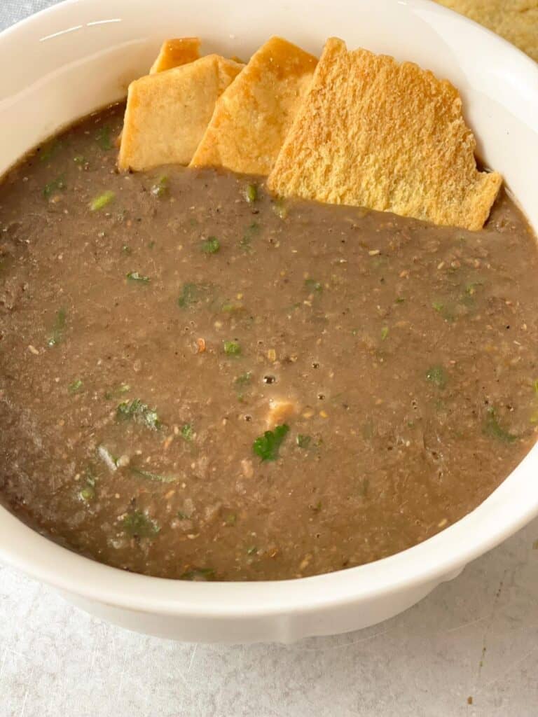 yummy hot bowl of brown lentil soup that combine many rich fresh flavor and paired with pita bread