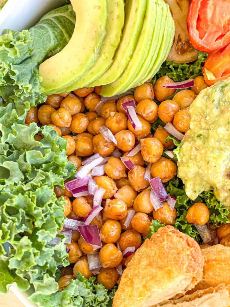 This delicious Roasted Chickpea Avocado Salad features kale, a variety of yummy veggies, and crunchy roasted chickpeas with a creamy avocado dressing.