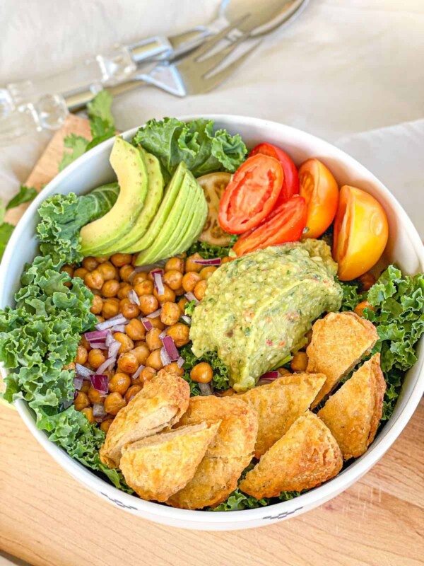 This delicious roasted chickpea avocado salad features kale, a variety of yummy veggies, and crunchy roasted chickpeas with a creamy avocado dressing for a mouthwatering combo you’ll love.