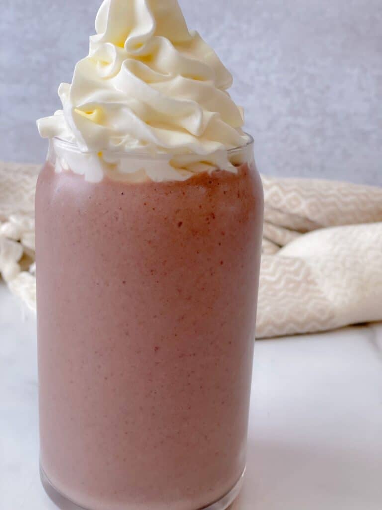 This fruity and delicious Acai Panut Butter shake is best served with a topping of fluffy whipped cream.