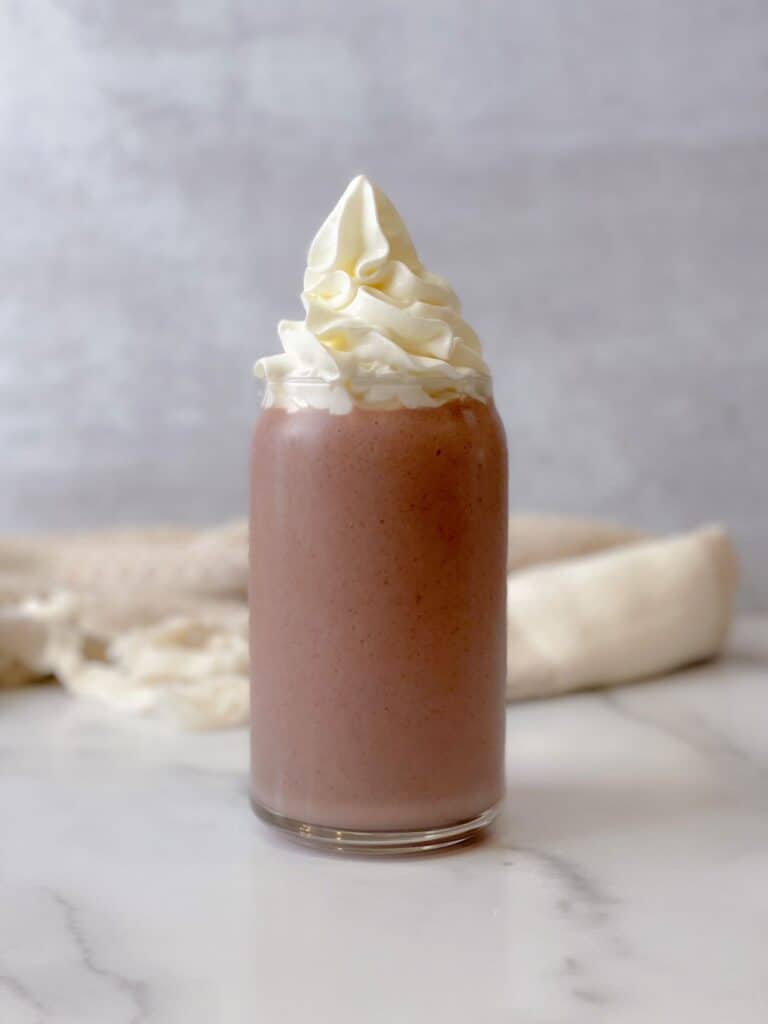 This fruity Acai Peanut Butter Shake is filled with all the right flavors for a morning boost. Top it off with whipped cream and enjoy a cold delicious smoothie.