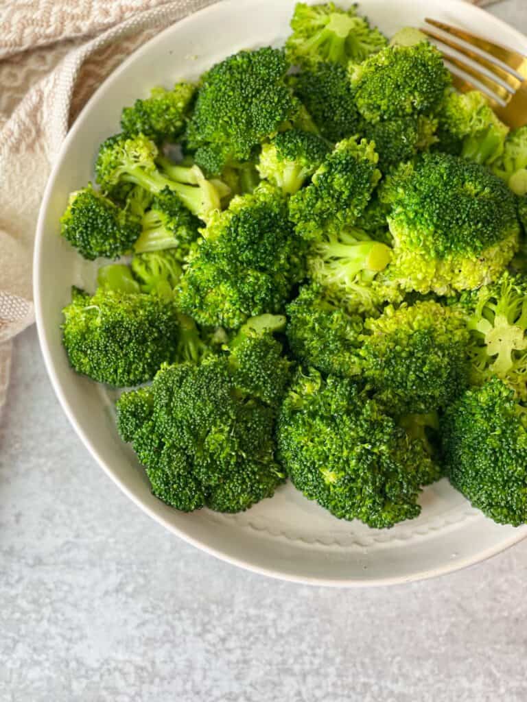 Perfectly seasoned, crisp and bright green broccoli seasoned with salt, olive oil, and ground pepper.