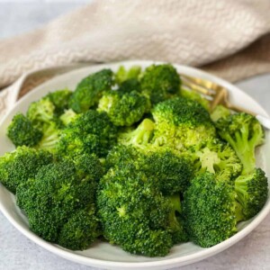 Perfectly boiled and seasoned broccoli in a plate.