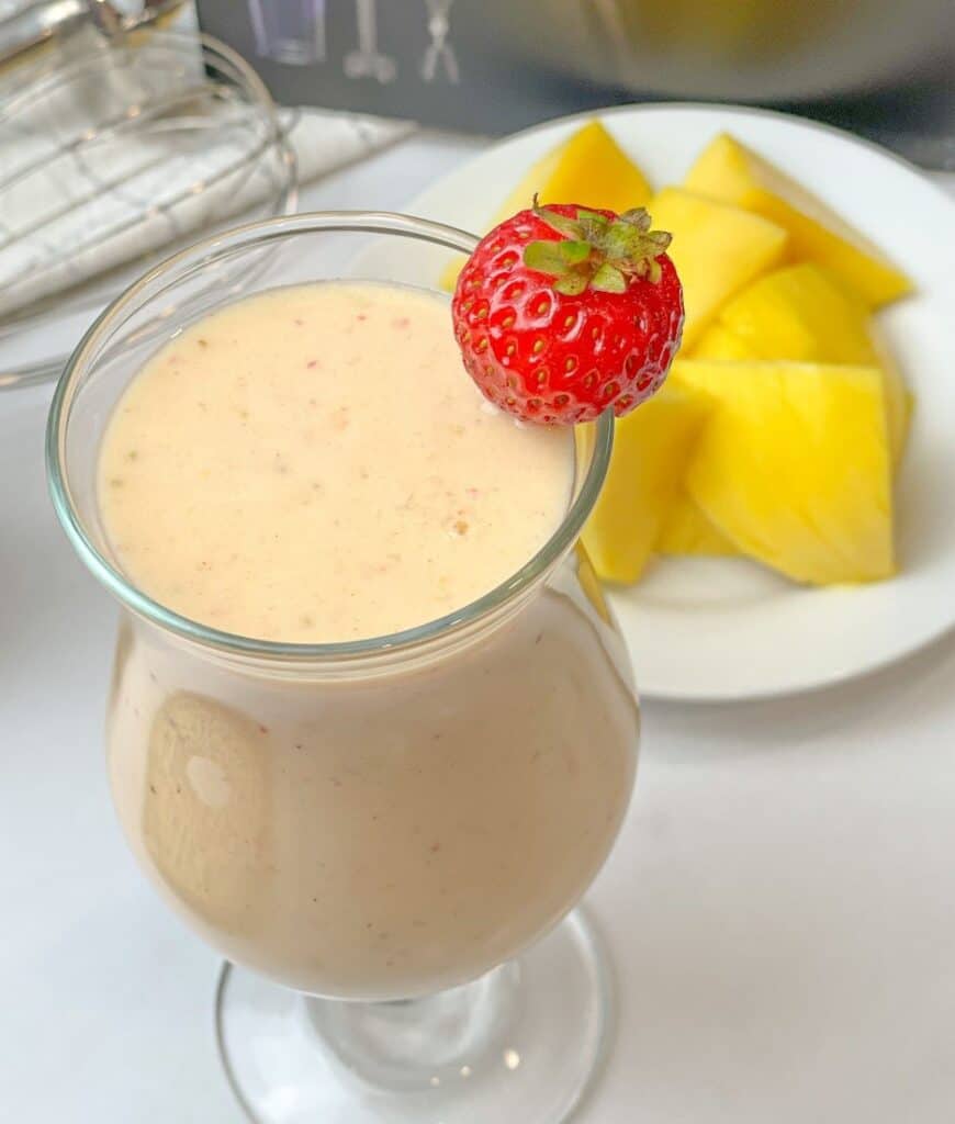 The strawberry and mango once blended with banana and milk will definitely give you a tasty smoothie that you will never forget. A tall glass of fruit vitamin smoothie with a strawberry decoration