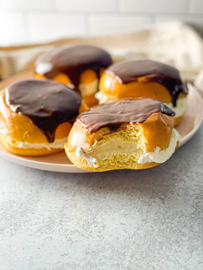 A delicious combo of soft buns, whipped cream, and glossy chocolate ganache! These Boston cream buns will be a hit with your family.