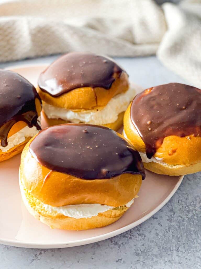 Featuring a light bun, silky smooth whipped cream filling, and  shiny chocolate ganache, these cream filled buns are totally additive!