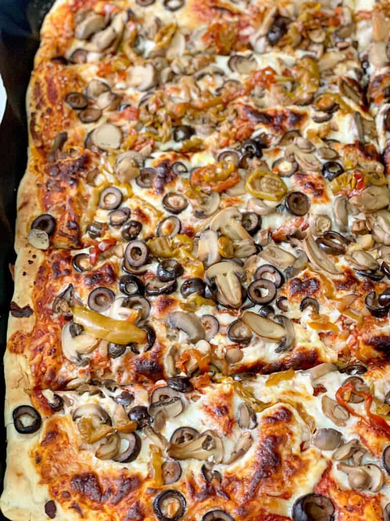 This homemade Pizza Dough recipe presents the ultimate family dinner. Layered with melting stretchy cheese and your favorite toppings. 