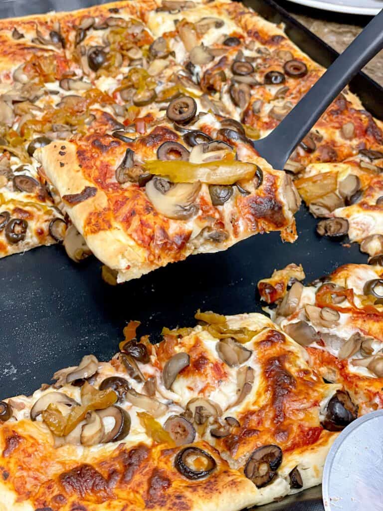 This homemade Pizza Dough recipe presents the ultimate family dinner. Layered with melting stretchy cheese and your favorite toppings. 