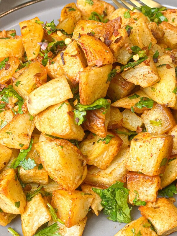 Tender potatoes infused with bold spices and tossed with fresh cilantro, creating a mouthwatering side dish or flavorful topping. The perfect balance of heat and herbaceous freshness.