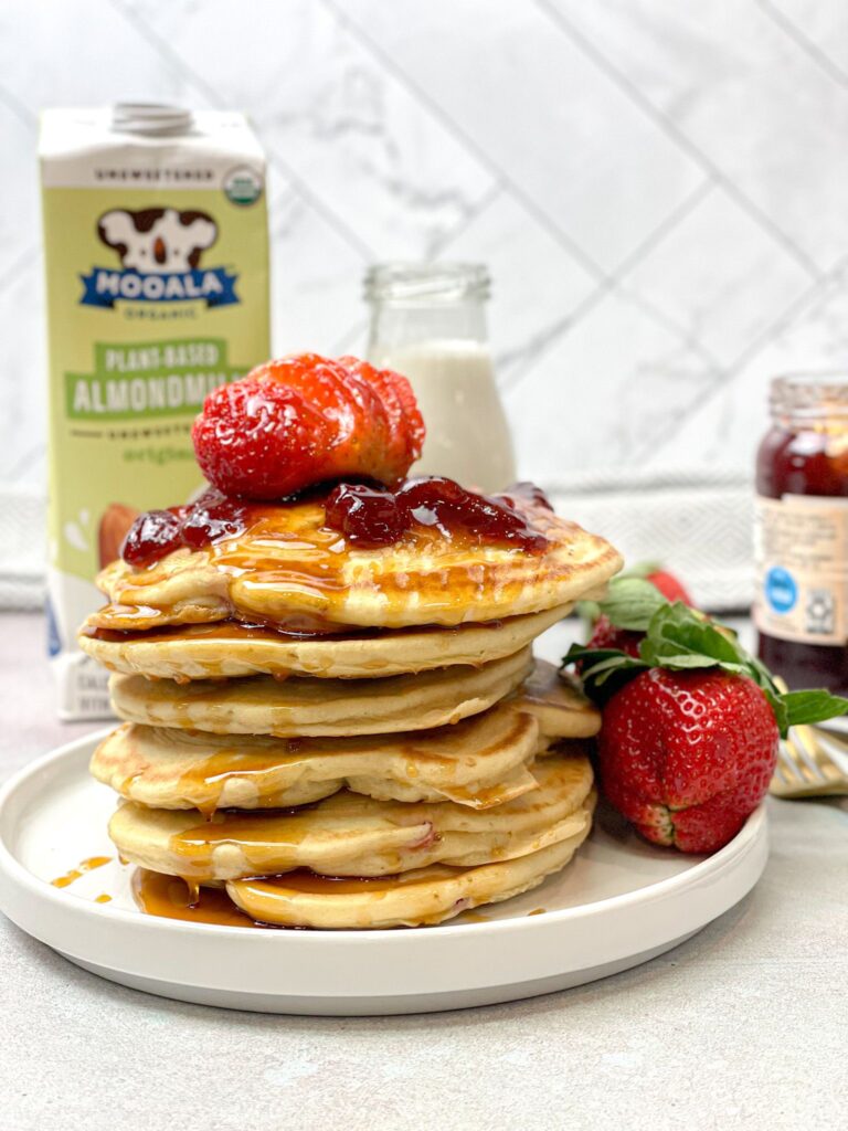 Fluffy pancakes topped with a decadent sweet strawberry jam and maple syrup. The perfect weekend breakfast!