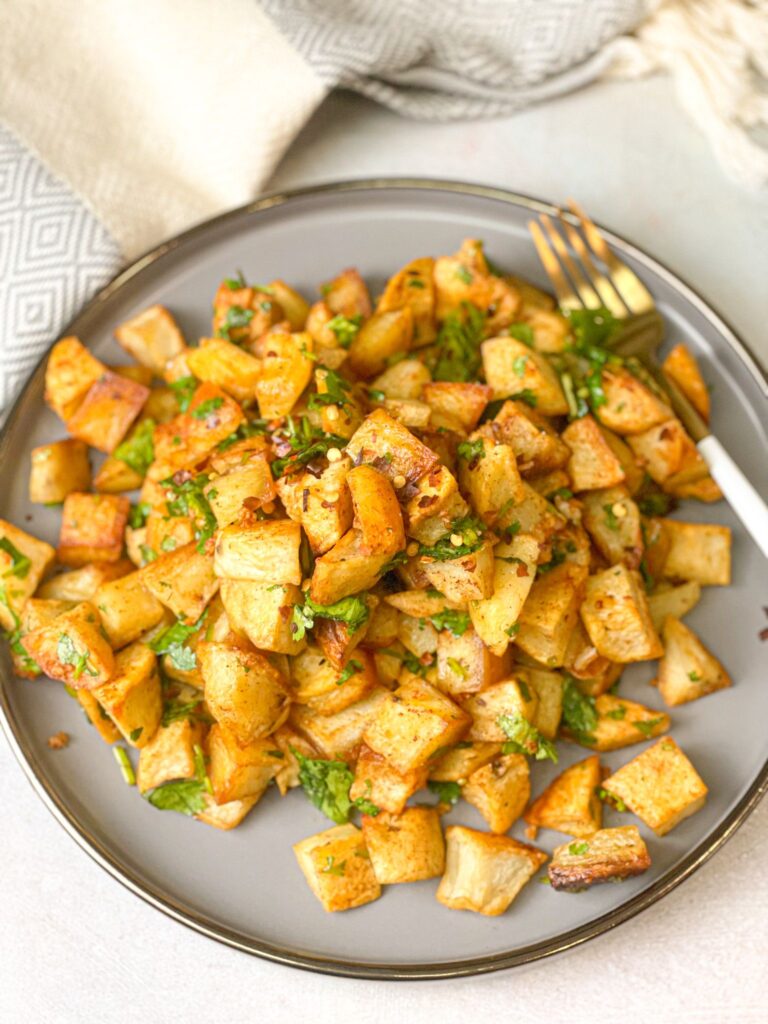 O skillet Middle eastern Potato (Batata Harra) served with some cilantro on top. A perfect side or main dish for dinner.