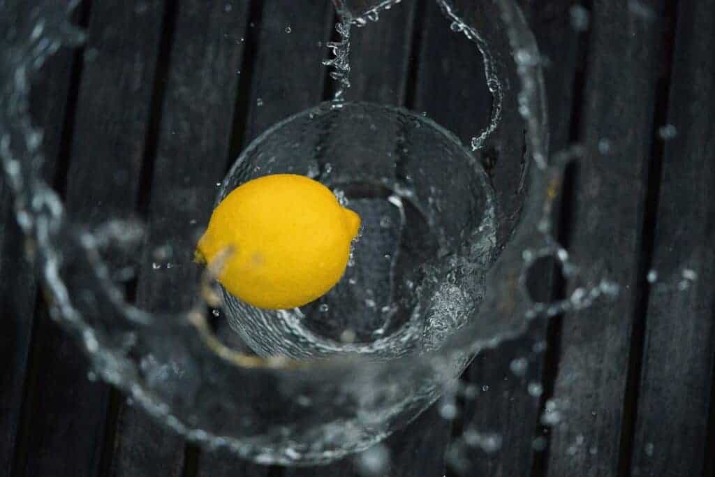Wash the yellow fresh lemons and get them ready to be stored in your freezer.