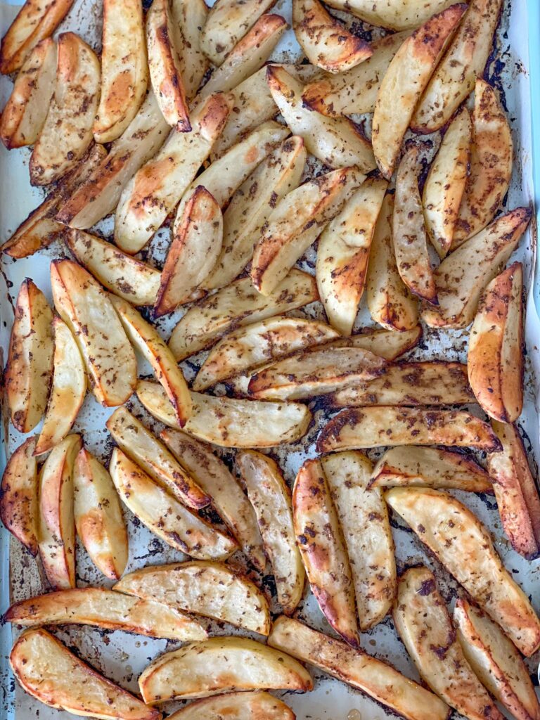 This KFC Copycat baked potato wedges recipe introduces perfectly spices, oven baked potato wedges. A Healthier crispy on the outside and tender on the inside version of your favorite side dish