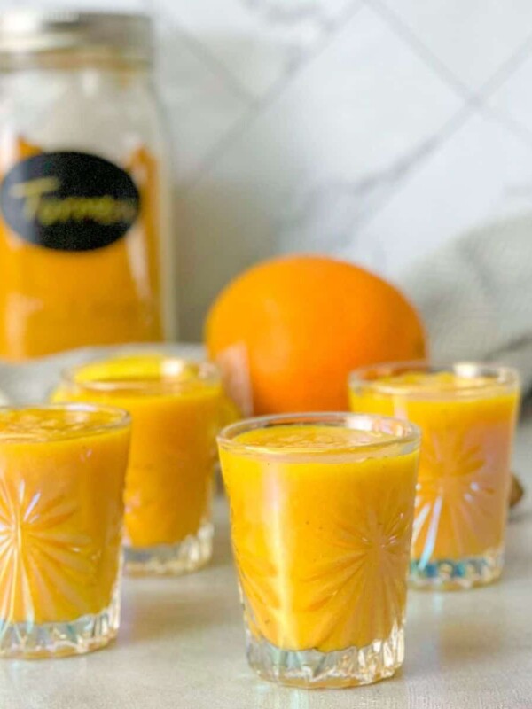 Ginger Turmeric Orange Lemon Shots poured in cups and ready to be served.