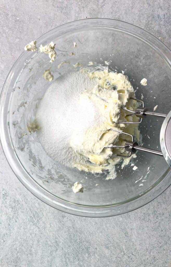 Add sugar to whip with cream cheese, milk, and vanilla for the best frostiing.