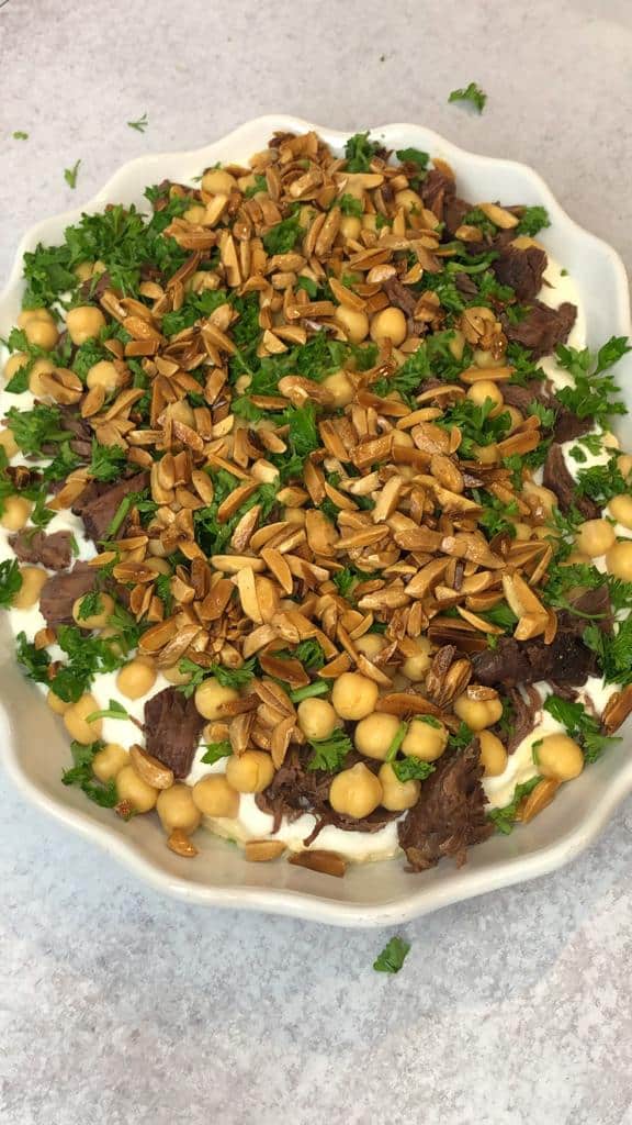 Fatteh with beef shanks layered with chickpeas and toasted pita bread.