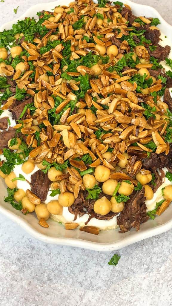 Fatteh with beef shanks layered with chickpeas and toasted pita bread.