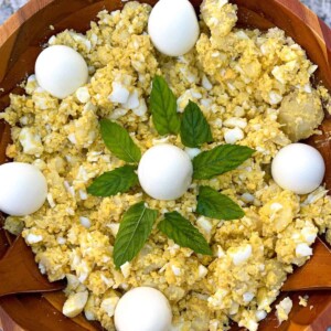 A traditional Middle Eastern dish combining tender boiled eggs and potatoes, seasoned with aromatic spices, creating a hearty and flavorful meal known as 'Batata w Beid'.