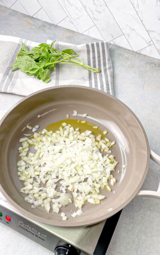 start by sauteing onions to make the gigi hadid viral pasta recipe