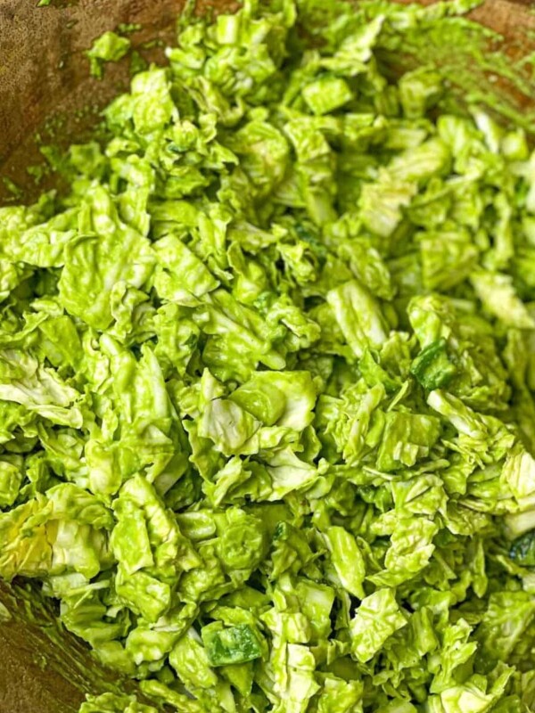 A bowl of finely chopped green salad with a green dressing.