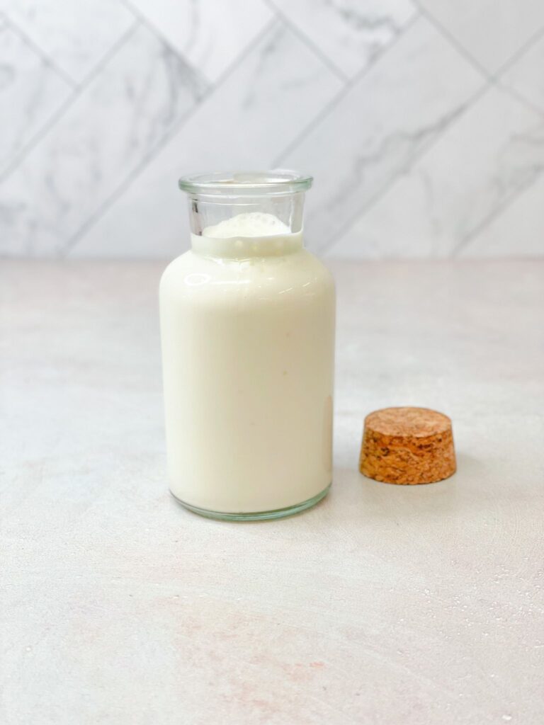 Creamy kefir yogurt stored in a class jar to be drunk on its own or added to your favorite smoothies.