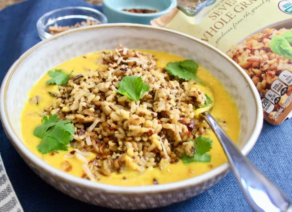 This golden coconut milk lentil stew with some rice and coconut flakes sprinkled on top makes the perfect week night meal.