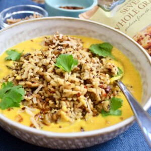 This golden coconut milk lentil stew with some rice and coconut flakes sprinkled on top makes the perfect weeknight meal.