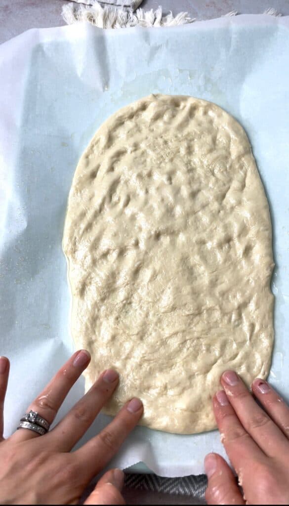 My 10 minute dough which I use to make all kinds of pies flattened into a wide rectangular shape and ready to filled with spinach and onions.