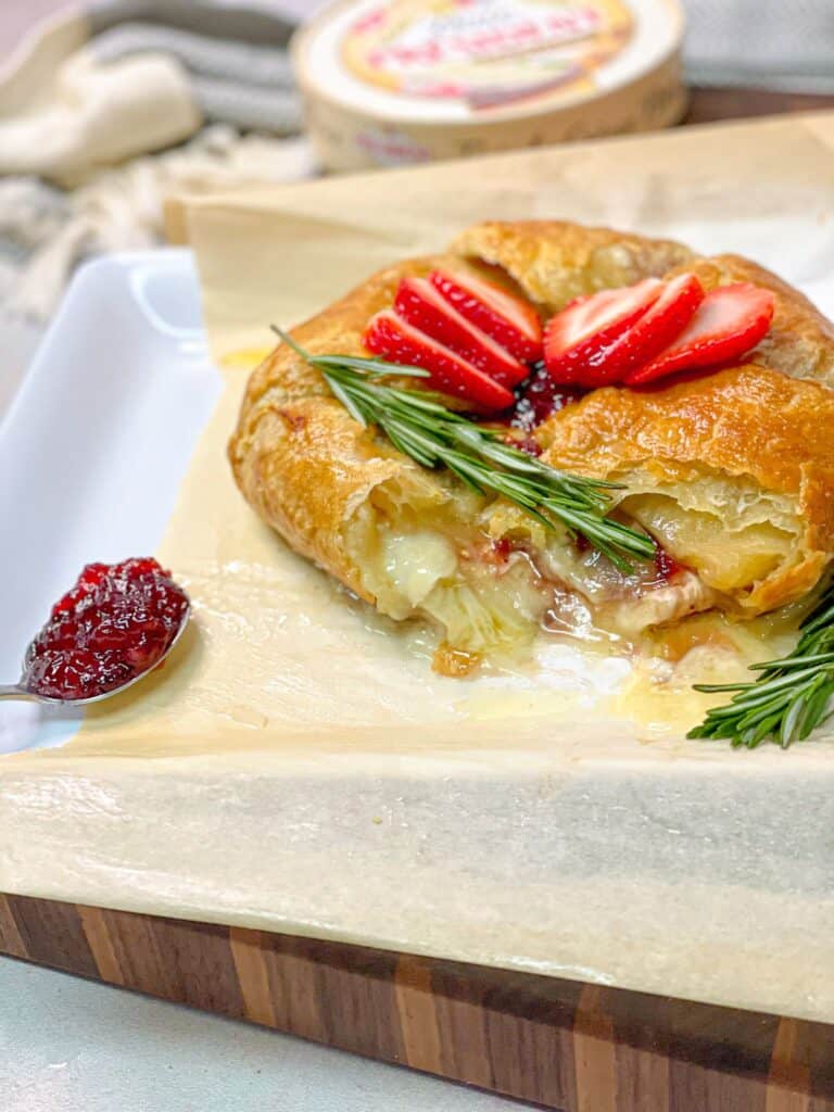 This strawberry jam baked brie in puff pastry is best eaten warm or at room temperature. Enjoy it with a side of crackers, fruits, or nuts.