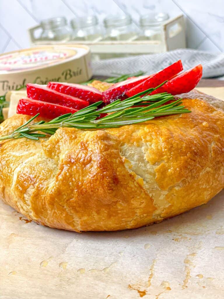 This strawberry jam baked brie in puff pastry allows you to enjoy delicious creamy cheese with your choice of jam and toppings.