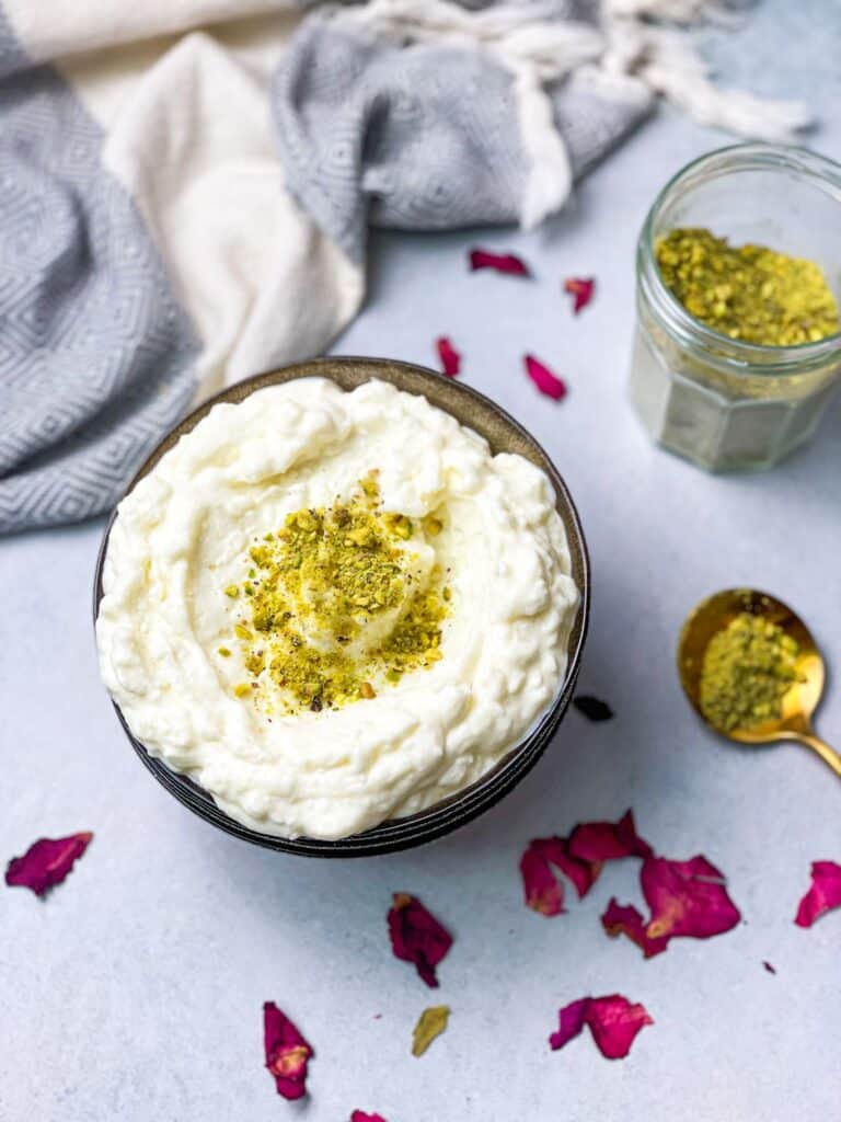 velvety smooth ashta in a bowl sprinkled with some pistachios 
