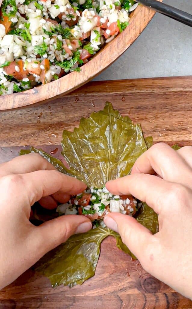 Set a teaspoon of vegan stuffing on the grape leaf.