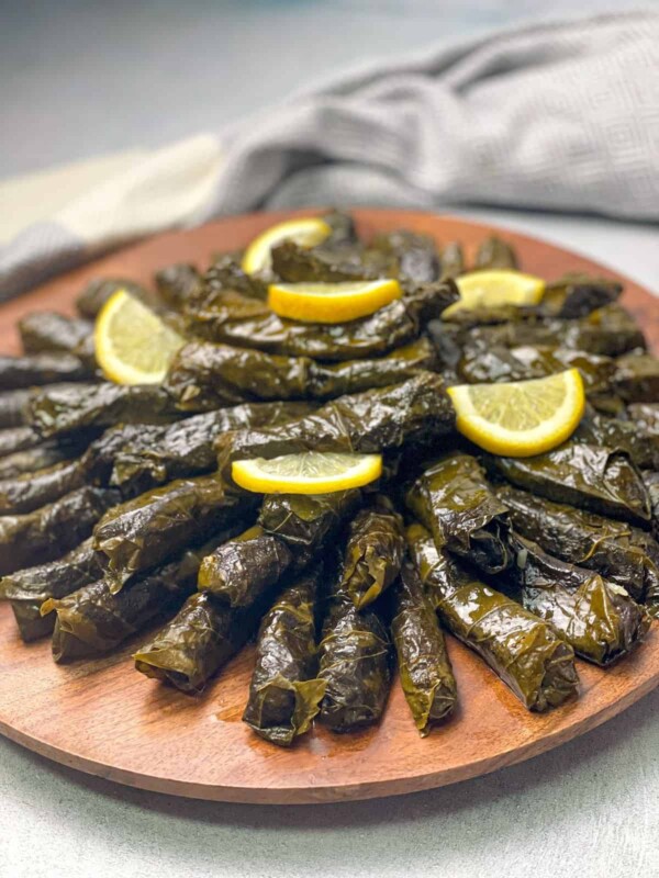 Vine leaves filled with vegetables and rice are easily, topped with fresh lemon slices.