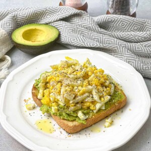 A nutritious and delicious breakfast or snack with this open-faced avocado toast adorned with slices of creamy boiled eggs.