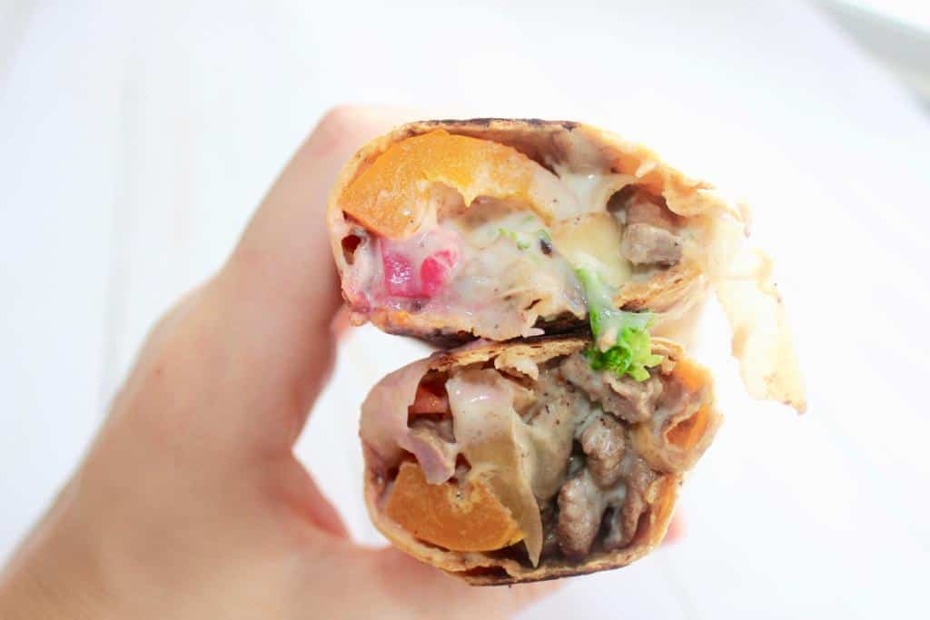 The ultimate beef shawarma sandwich is now at the tip of your fingers! Enjoy a colorful pita bread wrap filled with meat, vegetables, and delicious tahini sauce!