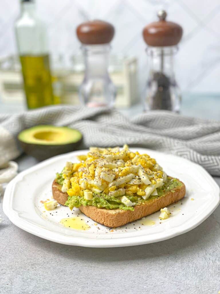 Whole grain toast topped with mashed avocados and protein packed boiled eggs.