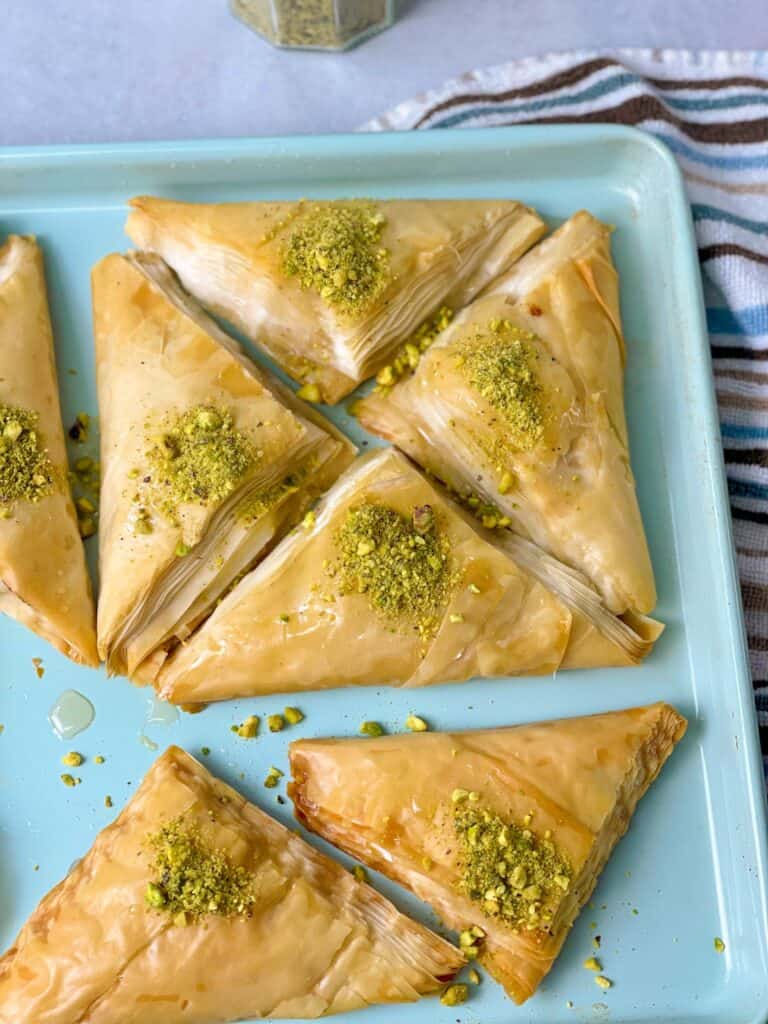 Crispy, dreamy, sweet, and delicious layers and layers of phyllo dough filled with a traditional homemade Lebanese Ashta cream filling and finished with a rose-water syrup. These warbat are delicious.