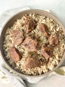 fluffy Lebanese rice with tender beef shanks on top