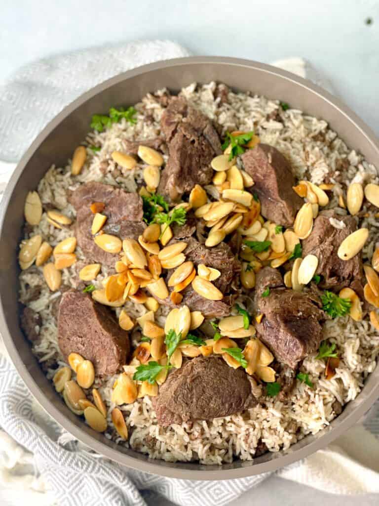 Spiced ground beef and rice are served with toasted almonds and shredded juicy meat.