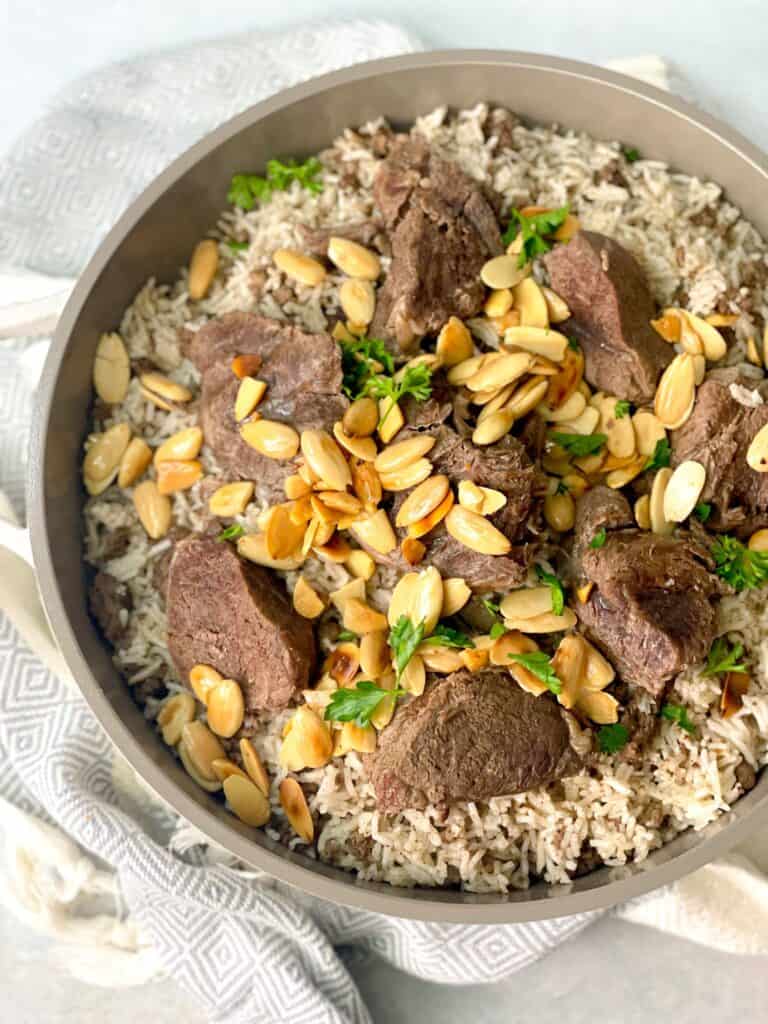 Tenderly cooked meat with toasted almonds atop fragrant spicy rice.