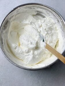 whipped cream and condensed milk in a bowl