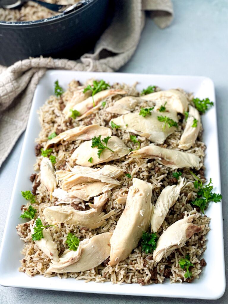 Delicious seasoned rice and ground meat topped with tender shredded chicken and minced parsley