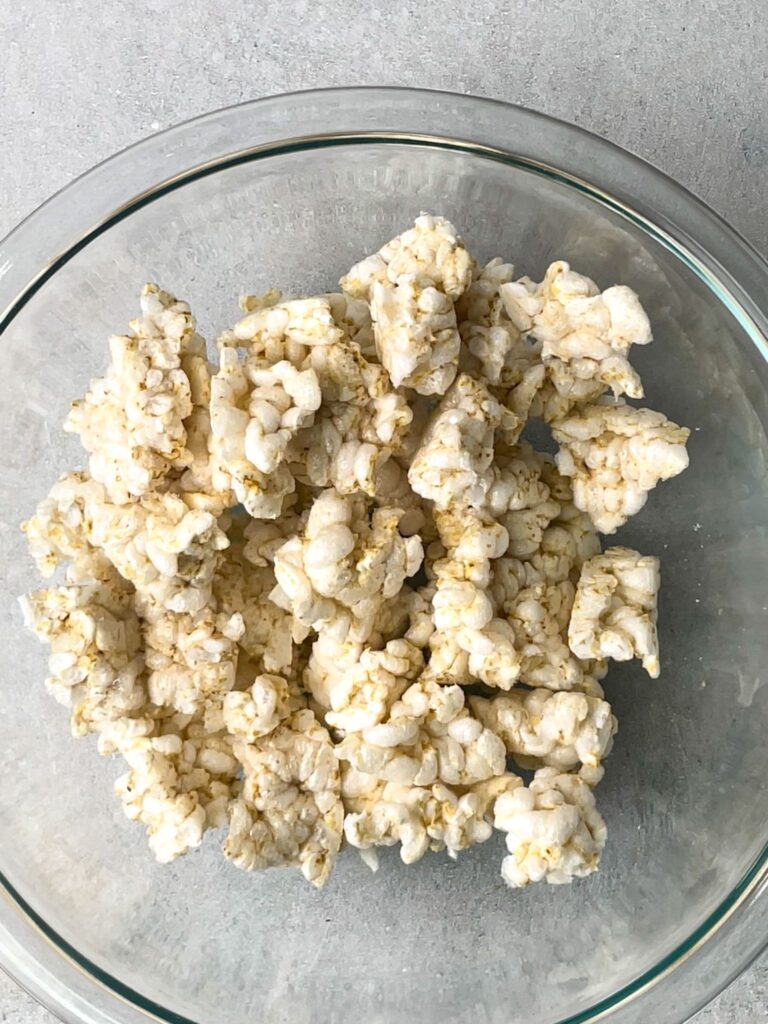This simple recipe starts by cracking rice cakes into a large bowl.