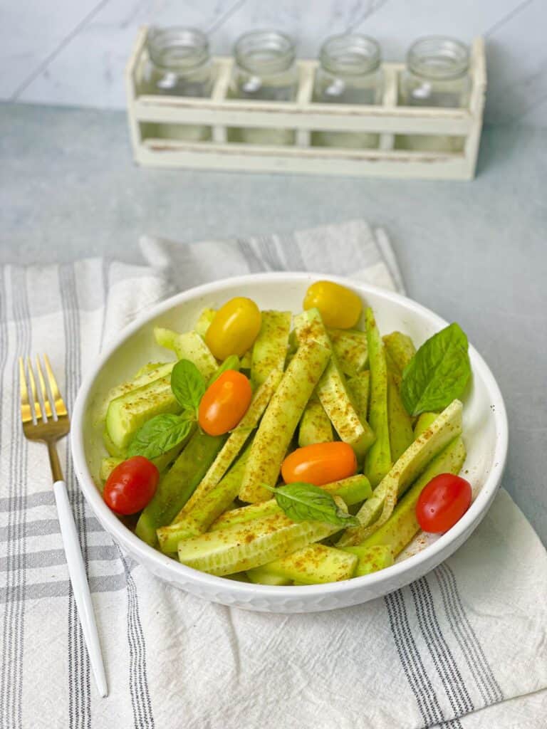 A summertime classic made of sliced cucumbers and cherry tomatoes tossed in a flavorful dressing of lemon juice, cumin, and salt.