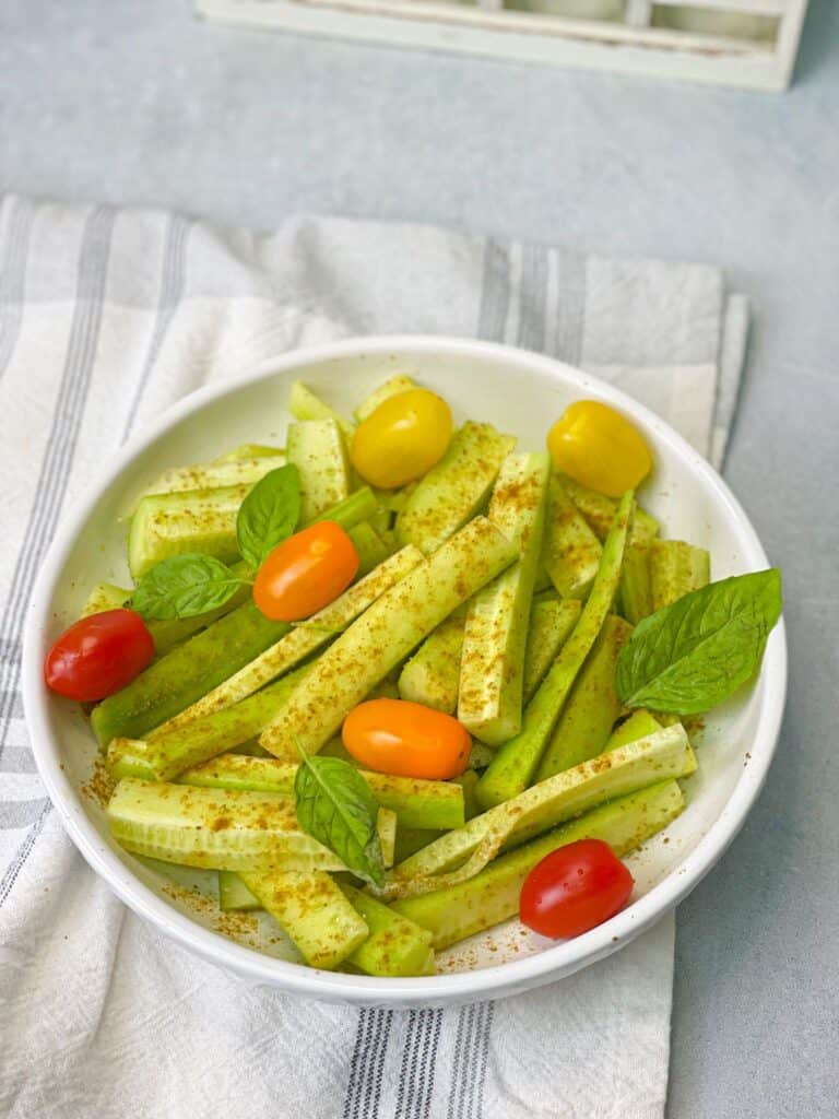 A summertime classic made of sliced cucumbers and cherry tomatoes tossed in a flavorful dressing of lemon juice, cumin, and salt.