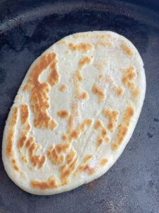 Soft, puffy, gluten free naan bread dough with beautiful brown blisters just like traditional Indian naan. 