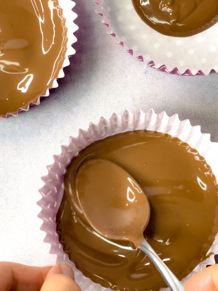 Melted chocolate spread on the cupcake liners